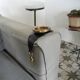 Old armrest ashtray with fleur-de-lis design in leather and brass.