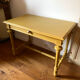 Desk table from the late 19th century, painted mustard, with turned stretcher.