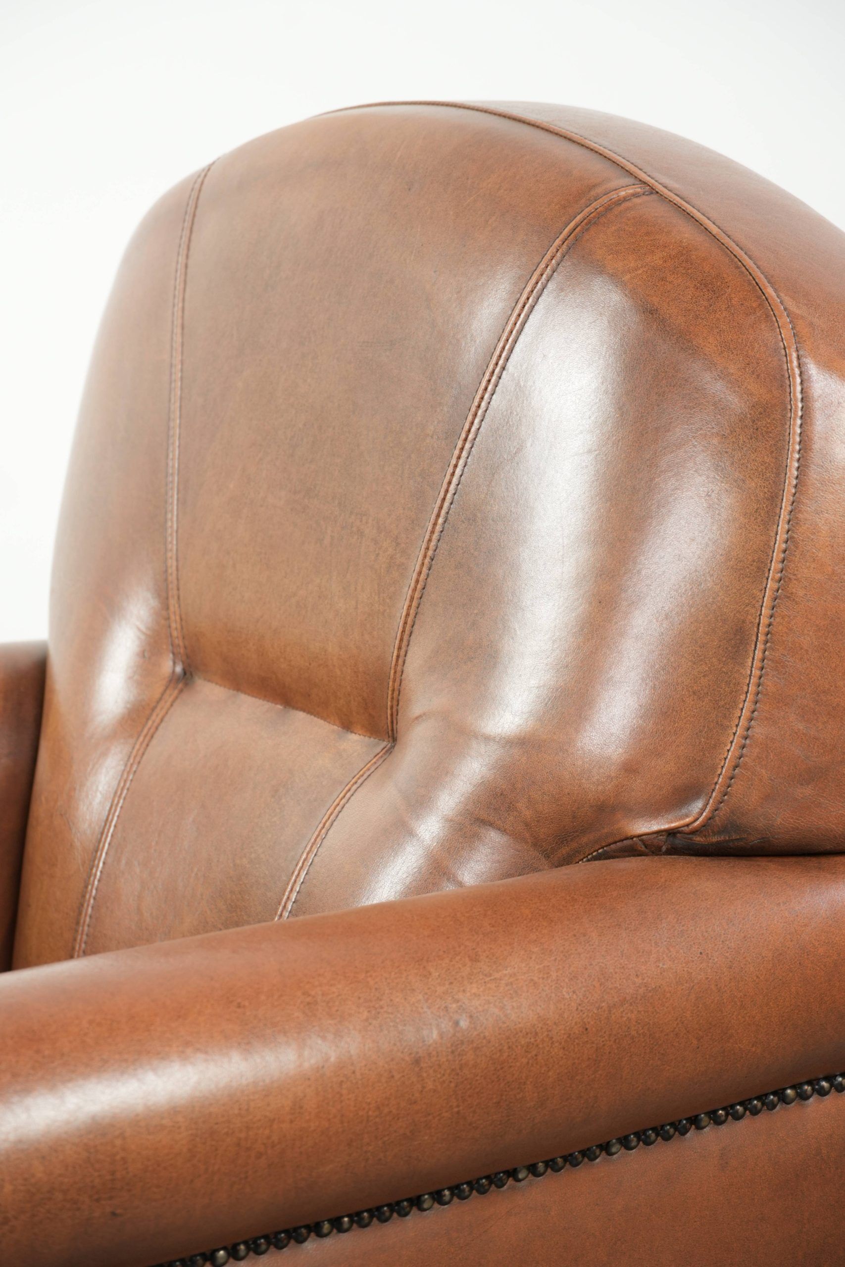 Armchair made of sheepskin leather with refined decorative nail finish