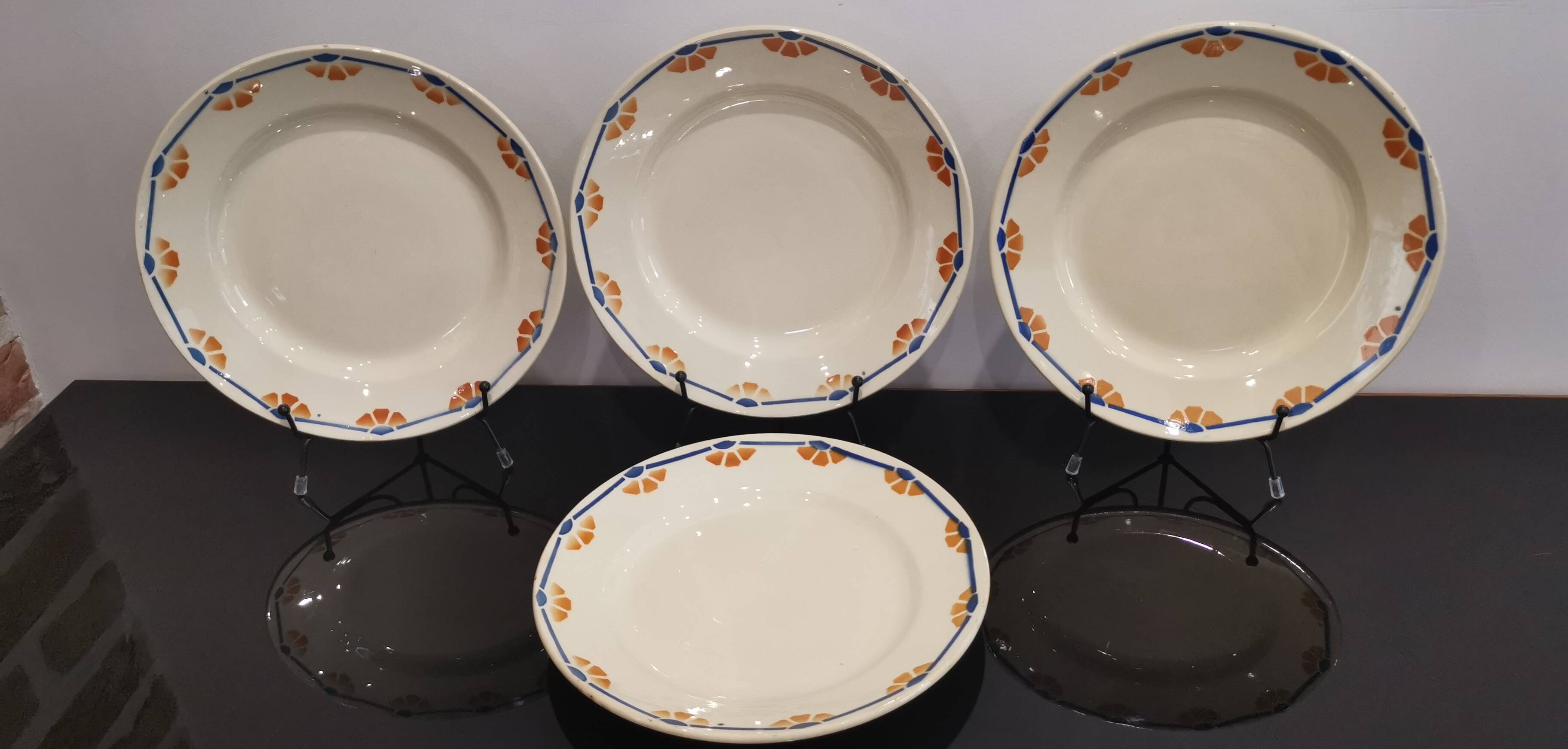 Old semi-deep plates in Terre de fer earthenware