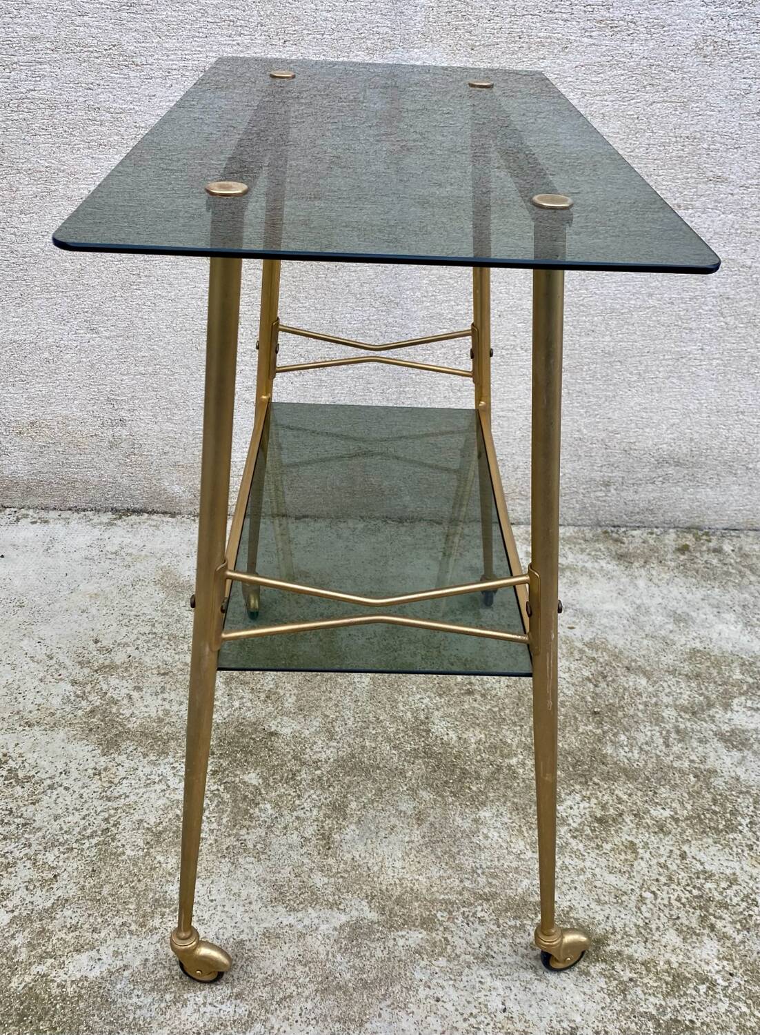 Vintage 1970s glass and gold rolling console table.