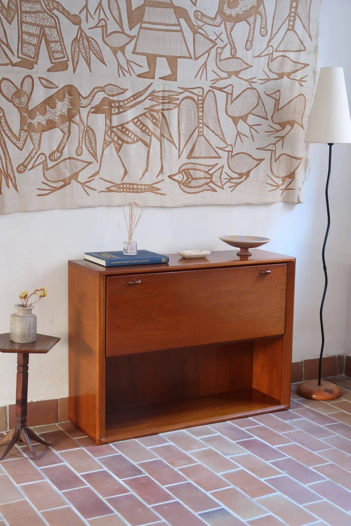 Vintage teak bar cabinet with black glass interior.