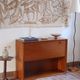 Vintage teak bar cabinet with black glass interior.