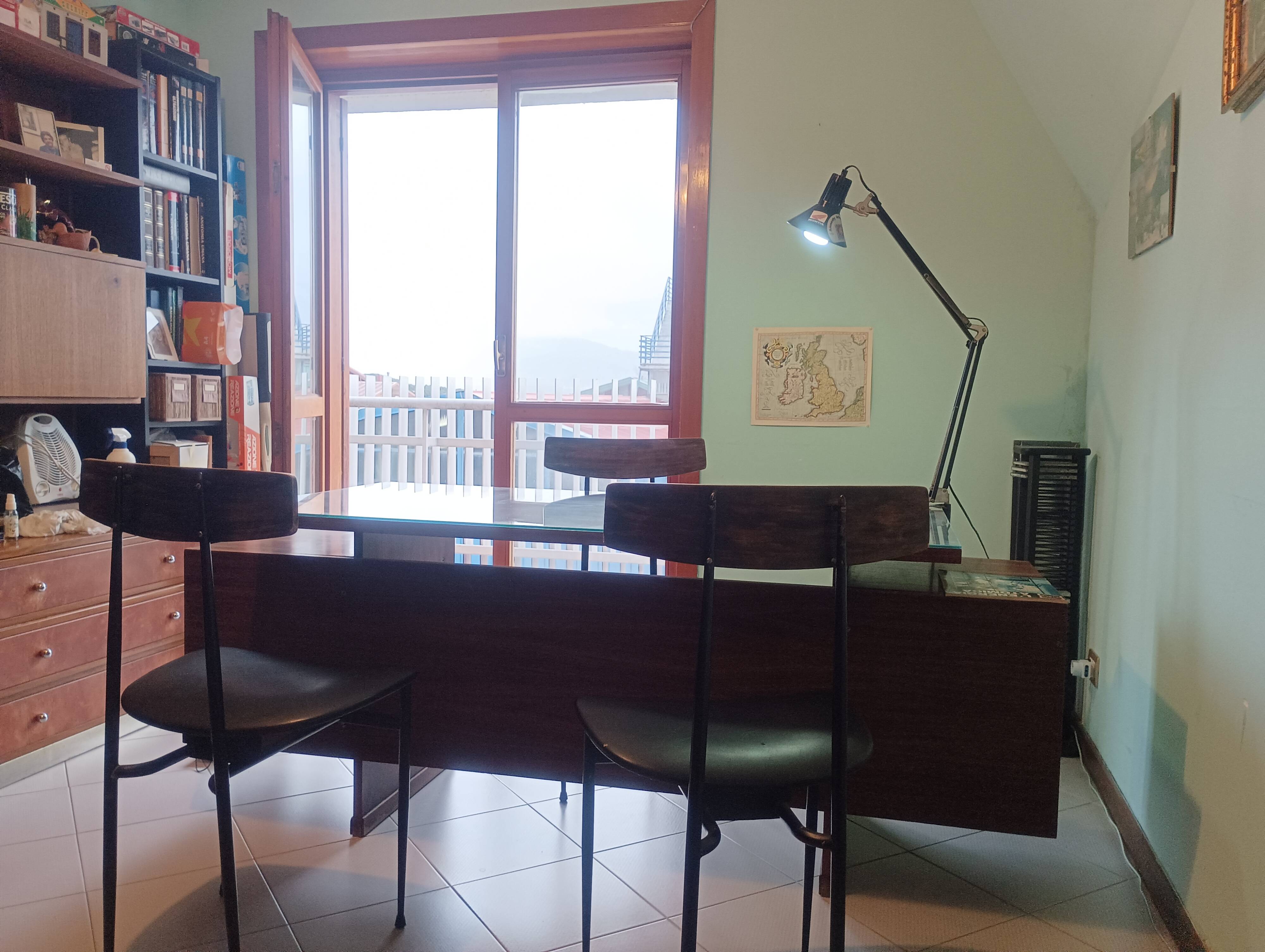 Desk and 3 chairs in 1950s Italian modernist style in rosewood.