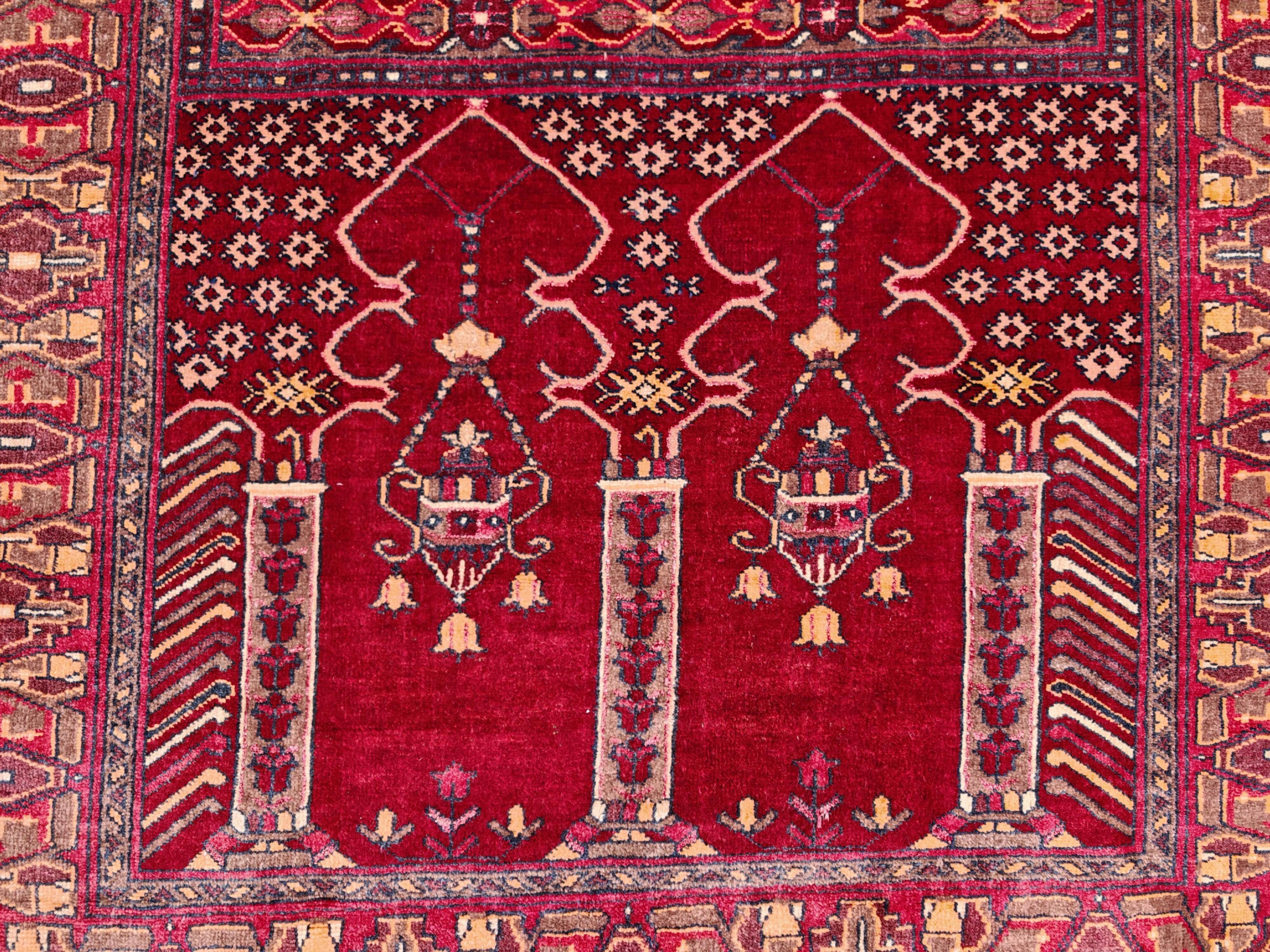 Vintage Afghan hand-knotted prayer rug with Islamic patterns.
