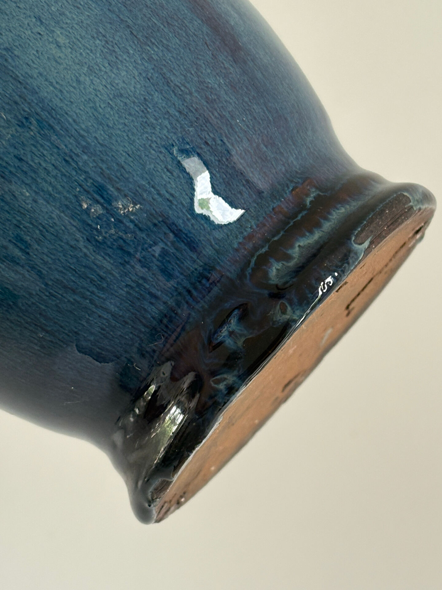 Decorative deep blue glazed ceramic vase with twin handles.