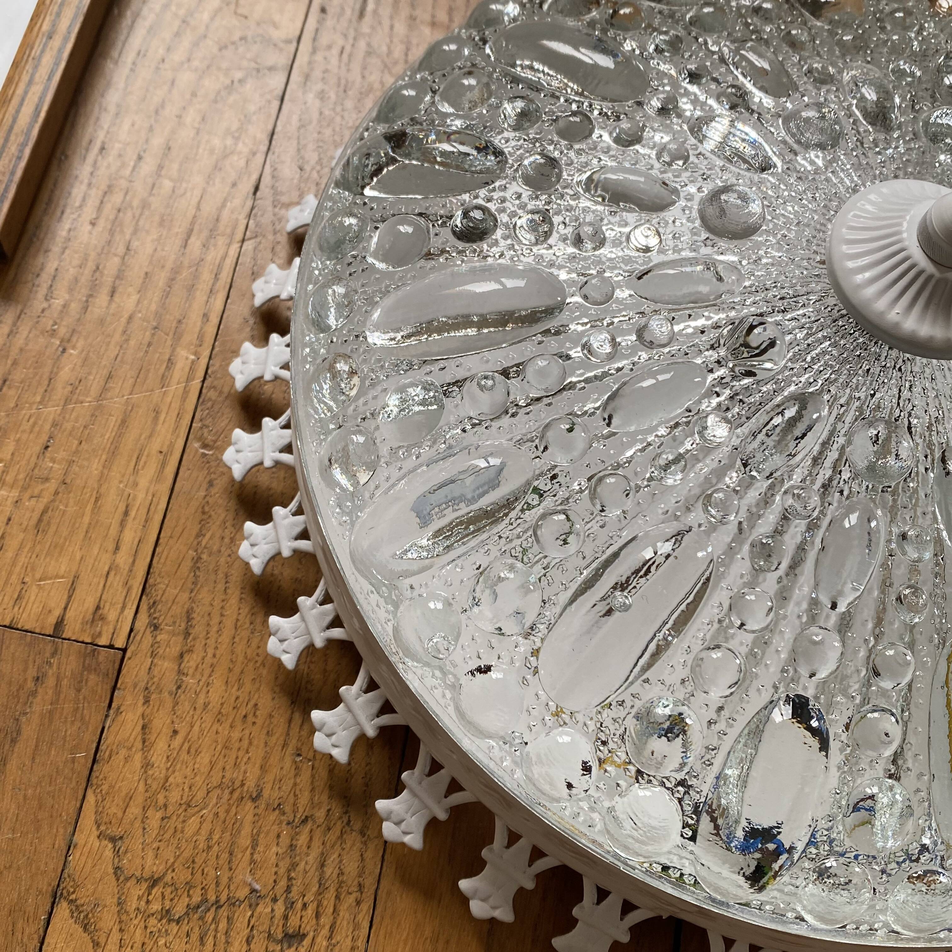 Antique ceiling light with transparent glass and white metal.