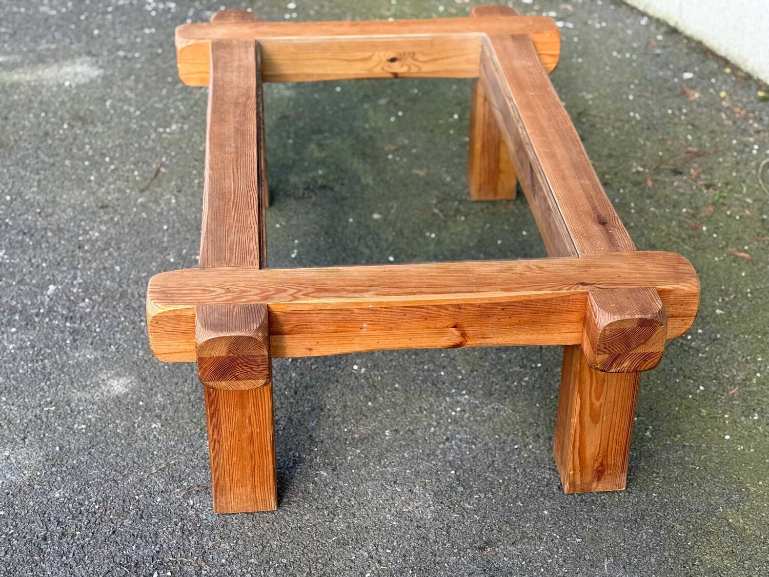 Coffee table with a glass top in Scandinavian brutalist style made of pine.