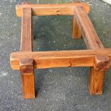 Coffee table with a glass top in Scandinavian brutalist style made of pine.