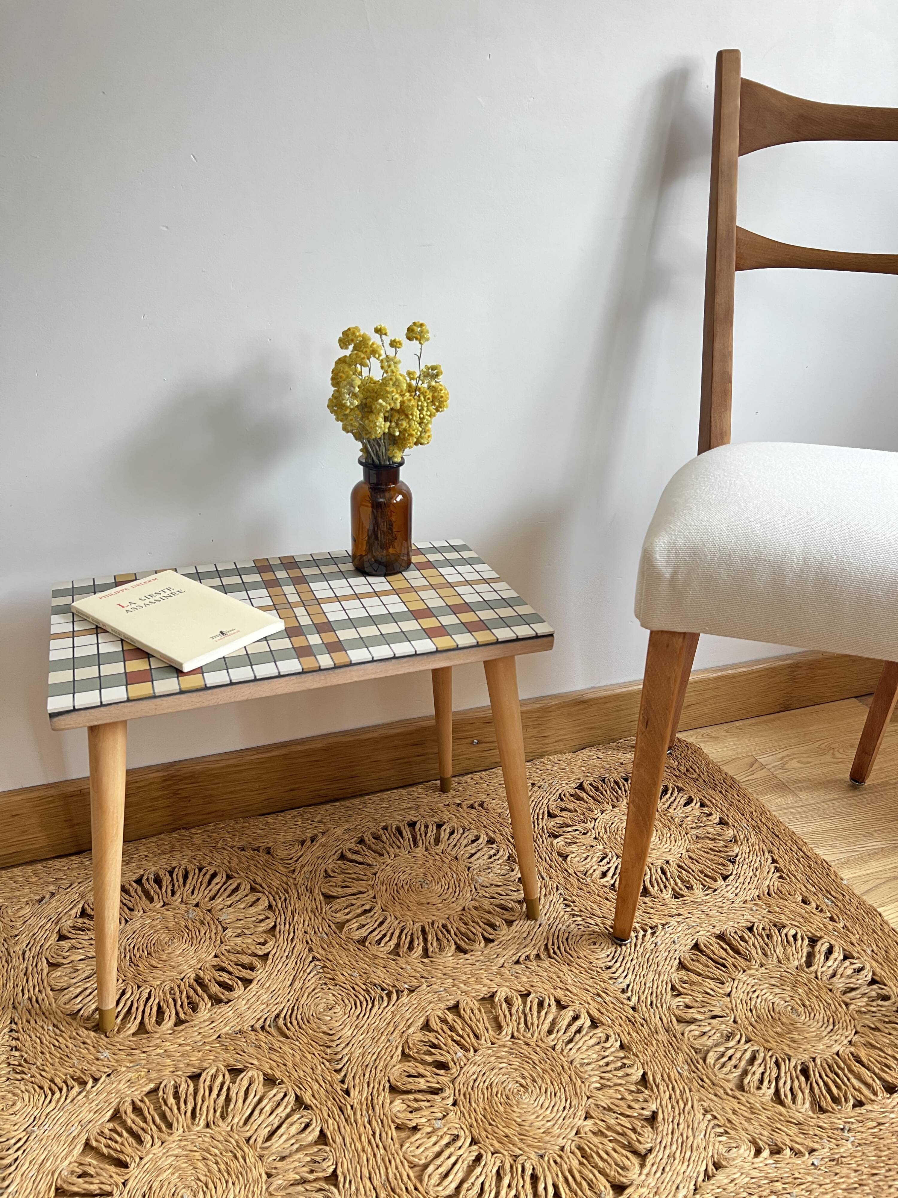 Small mosaic bedside table with tapered legs.