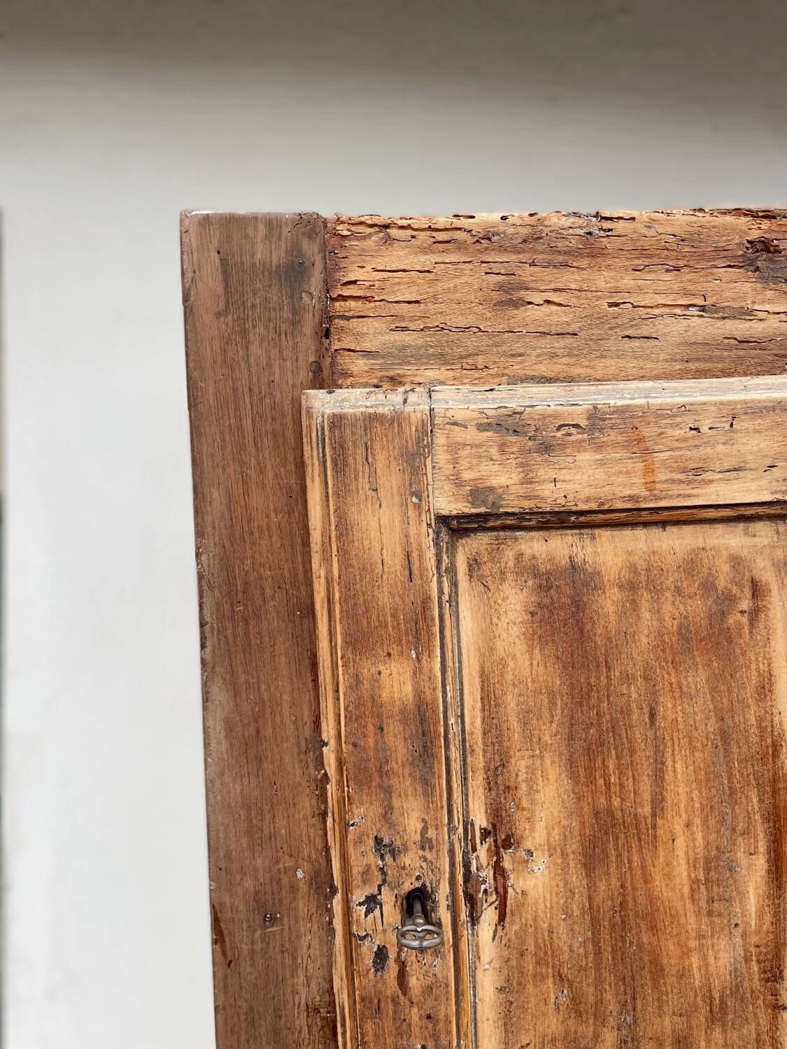 Rustic and vintage wardrobe in raw wood, wabi-sabi style.