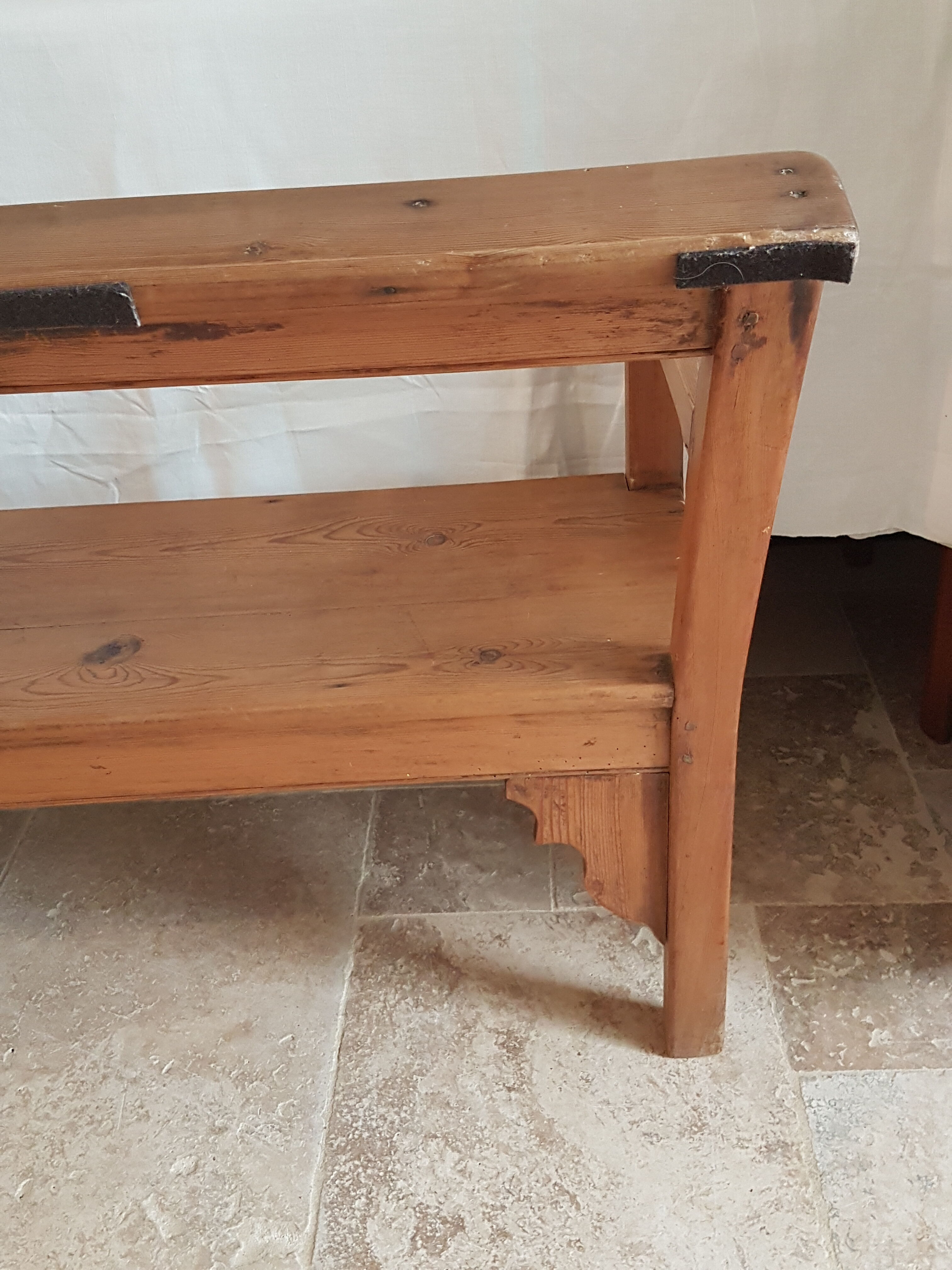 Church bench in fir tree with armrests