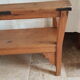 Church bench in fir tree with armrests