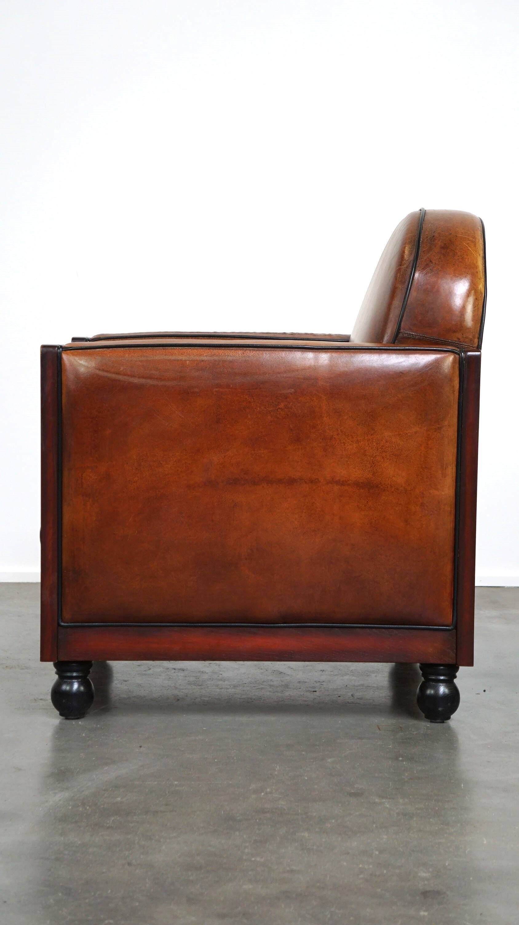 Sheepskin Art Deco design armchair with wood and beautiful cognac-colored leather