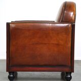 Sheepskin Art Deco design armchair with wood and beautiful cognac-colored leather