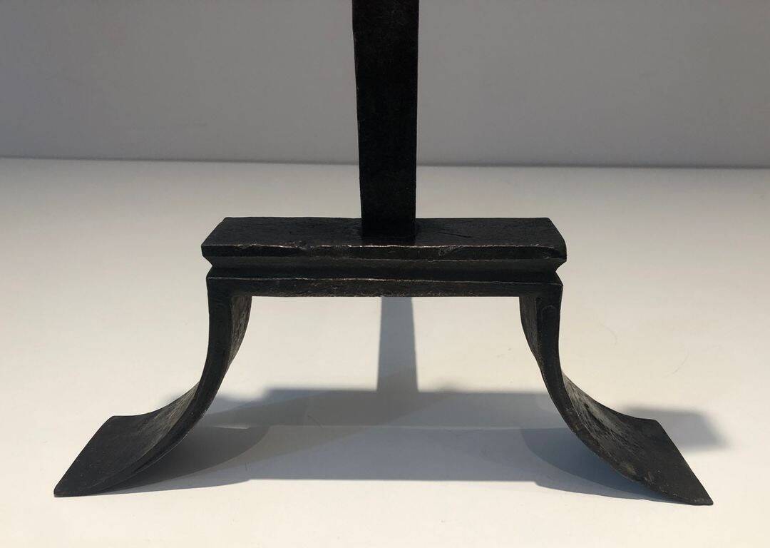 Important pair of wrought iron andirons with torch in heraldic fleur-de-lis design.