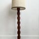 Brutalist floor lamp in turned wood, in the style of Charles Dudouyt.