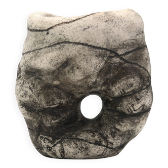 Ceramic vase sculpture decorated with faces and featuring a hole, 1980s.