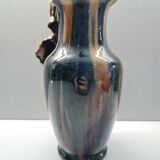 Terracotta vase with a child's head