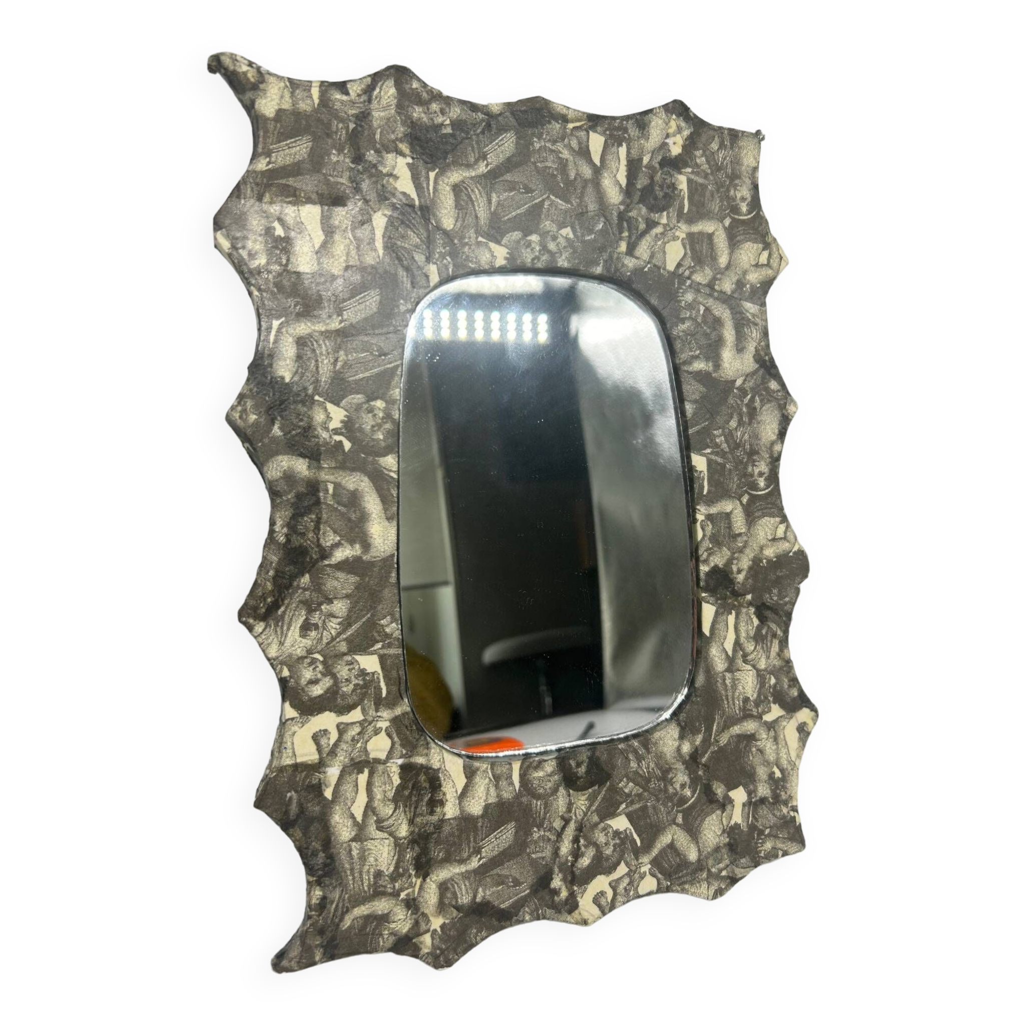 Free-form mirror decorated with cherubs.