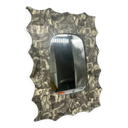 Free-form mirror decorated with cherubs.
