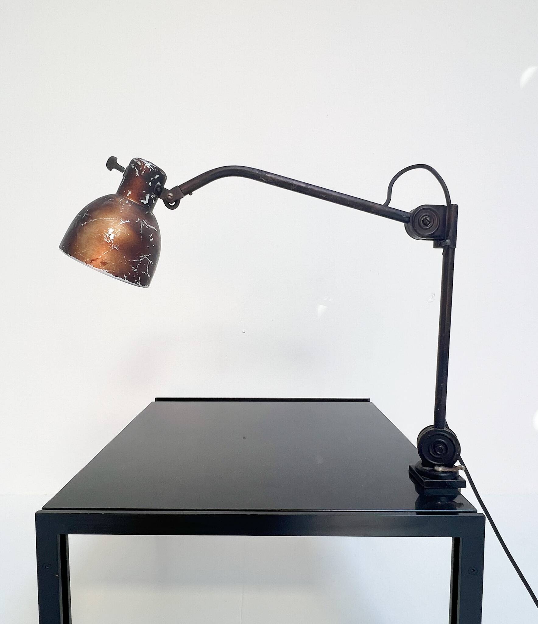 Industrial in height to be adjusted vintage clamp lamp from the 1970s