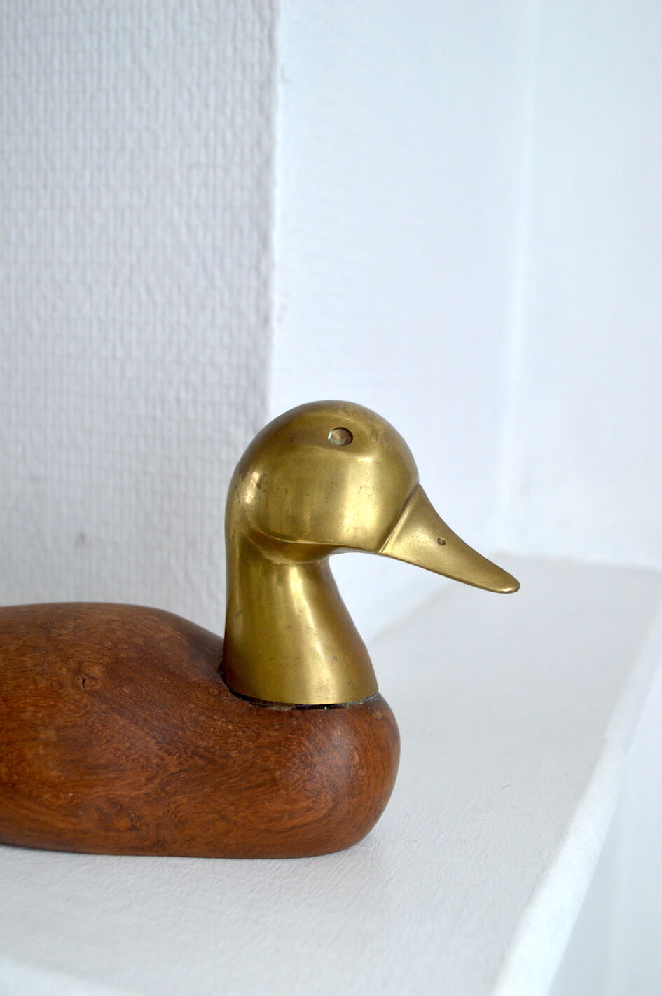 Wooden duck and brass