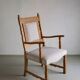 Carved oak armchair by Henning Kjaernulf | Denmark | 1960s