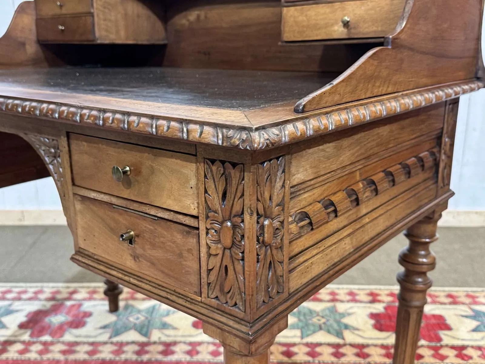 Louis XVI style desk from the late 19th century in walnut with a leather top.