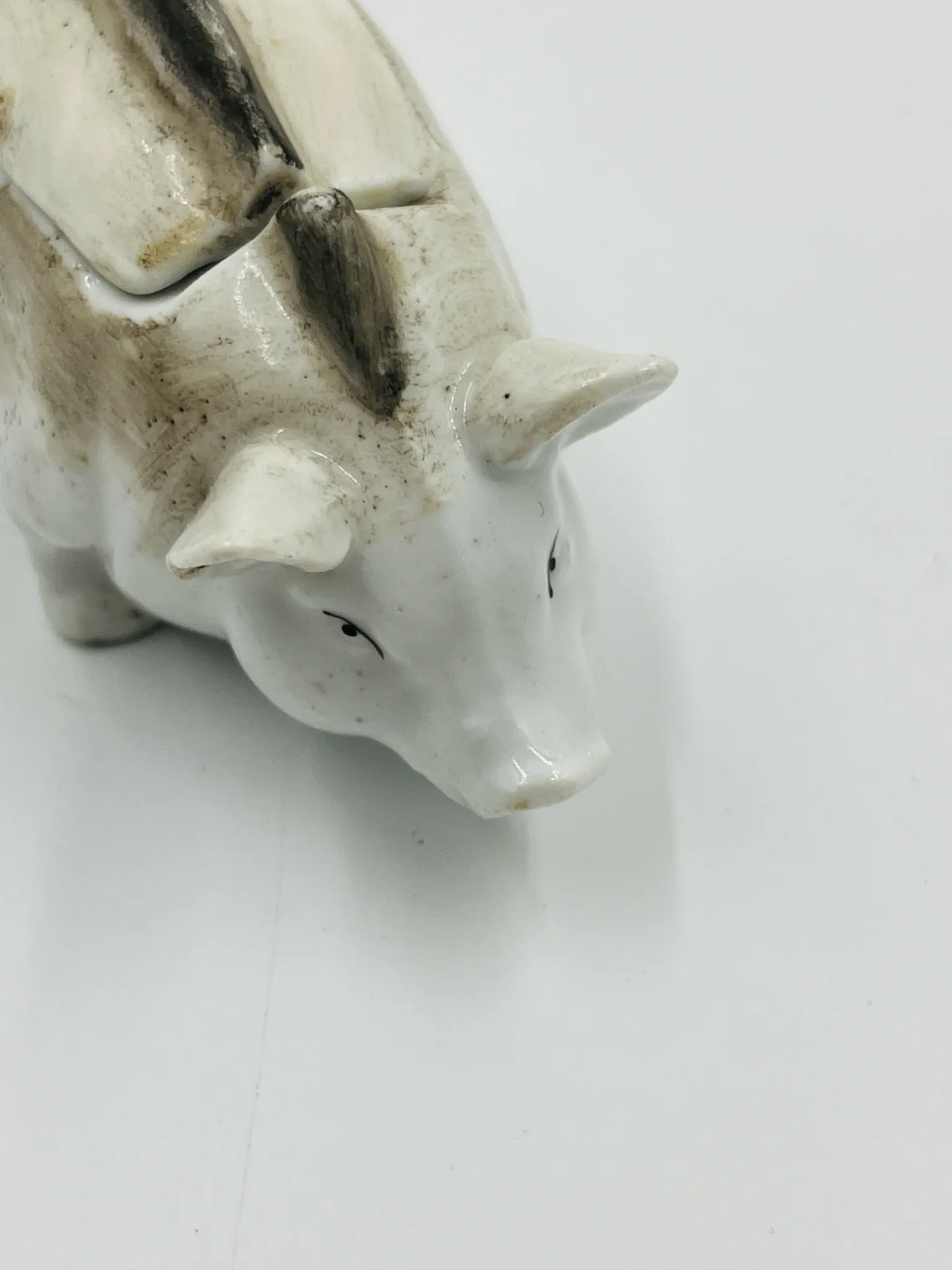 Vintage mustard pot in porcelain shaped like a pig.