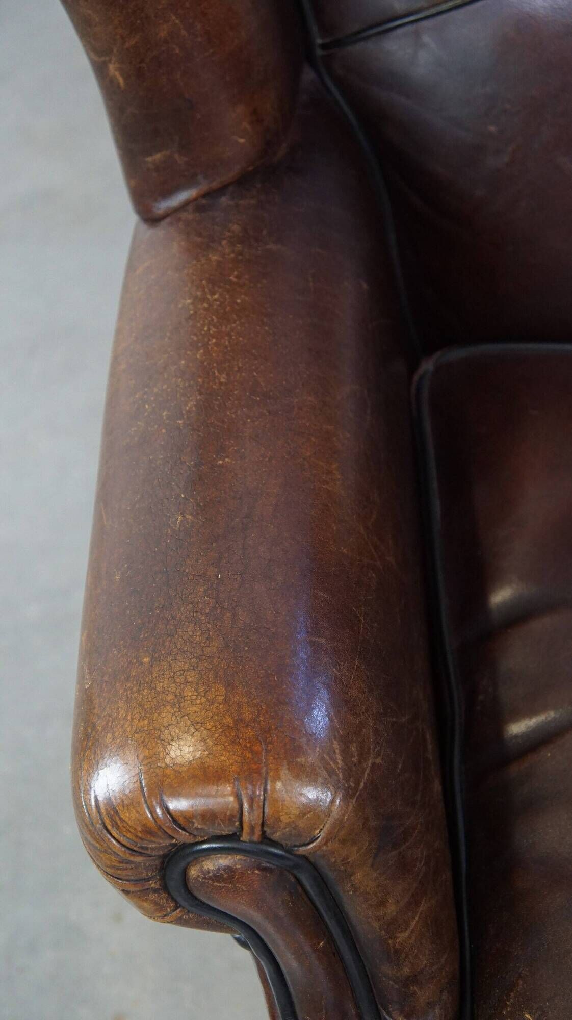Wing chair made of sheepskin and neatly finished with black piping