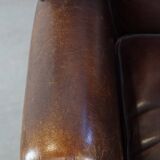 Wing chair made of sheepskin and neatly finished with black piping