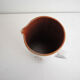 Old glazed terracotta carafe with signature