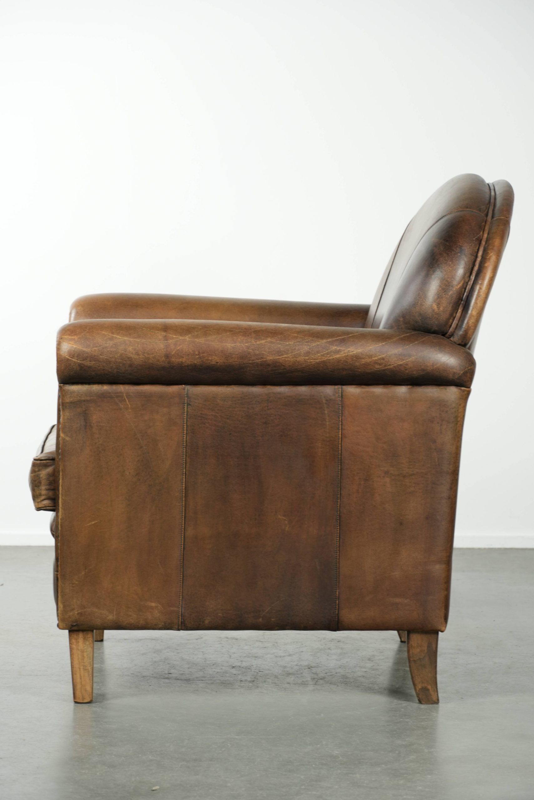 Armchair / lounge chair made of sheepskin leather with characterful patina