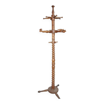Brown turned beech coat stand, sculpted column, stable tripod.