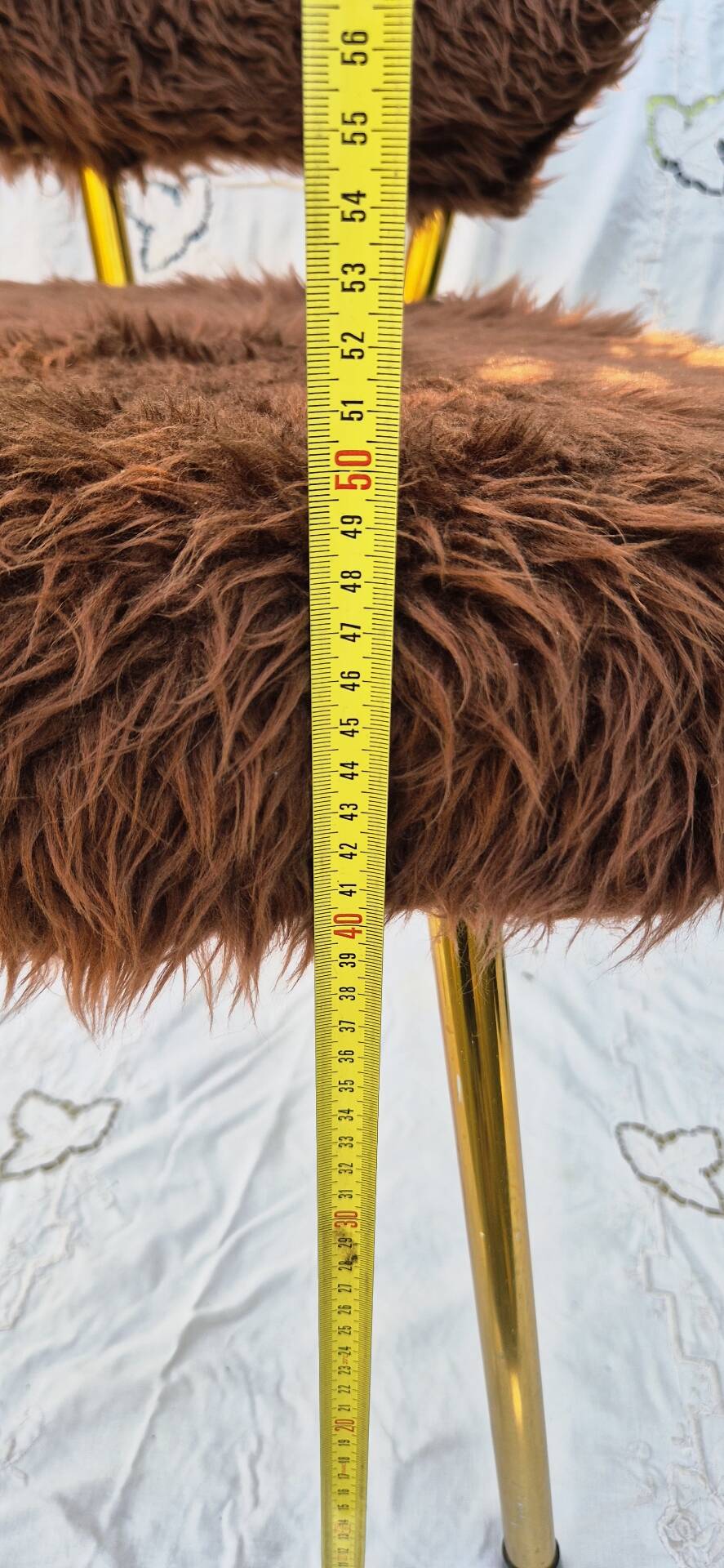 Vintage shaggy chair in faux fur with golden metal legs.