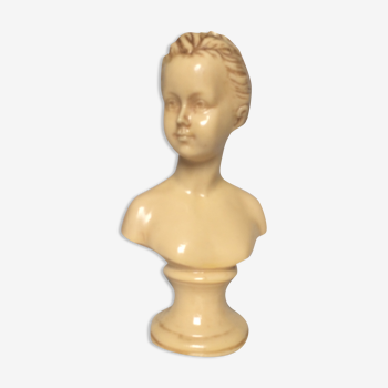 Bust in varnished dish, young girl with bun