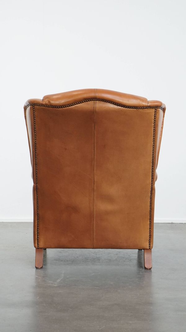 Fauteuil à oreilles en cuir de vache
