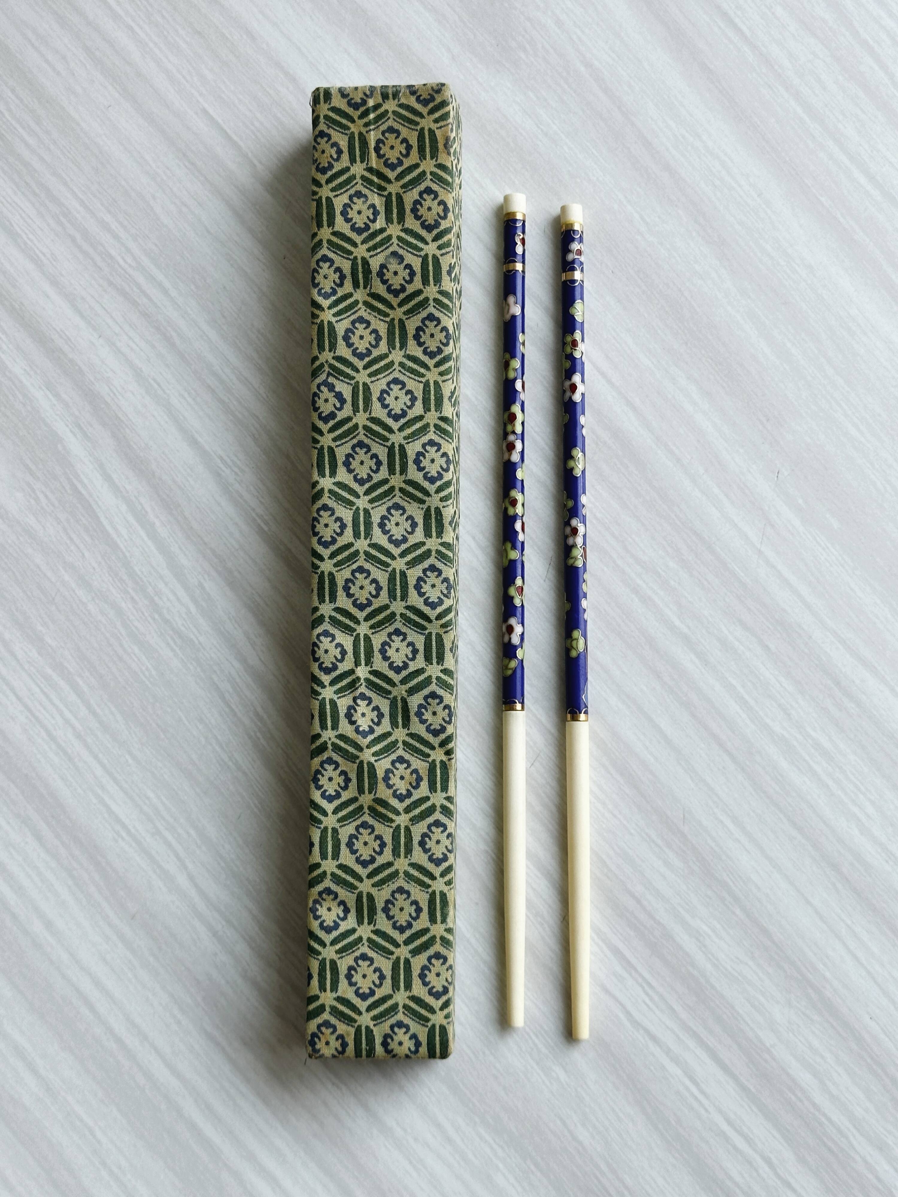 Blue chopsticks decorated with floral motifs.
