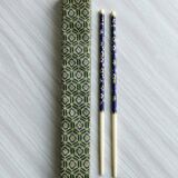 Blue chopsticks decorated with floral motifs.