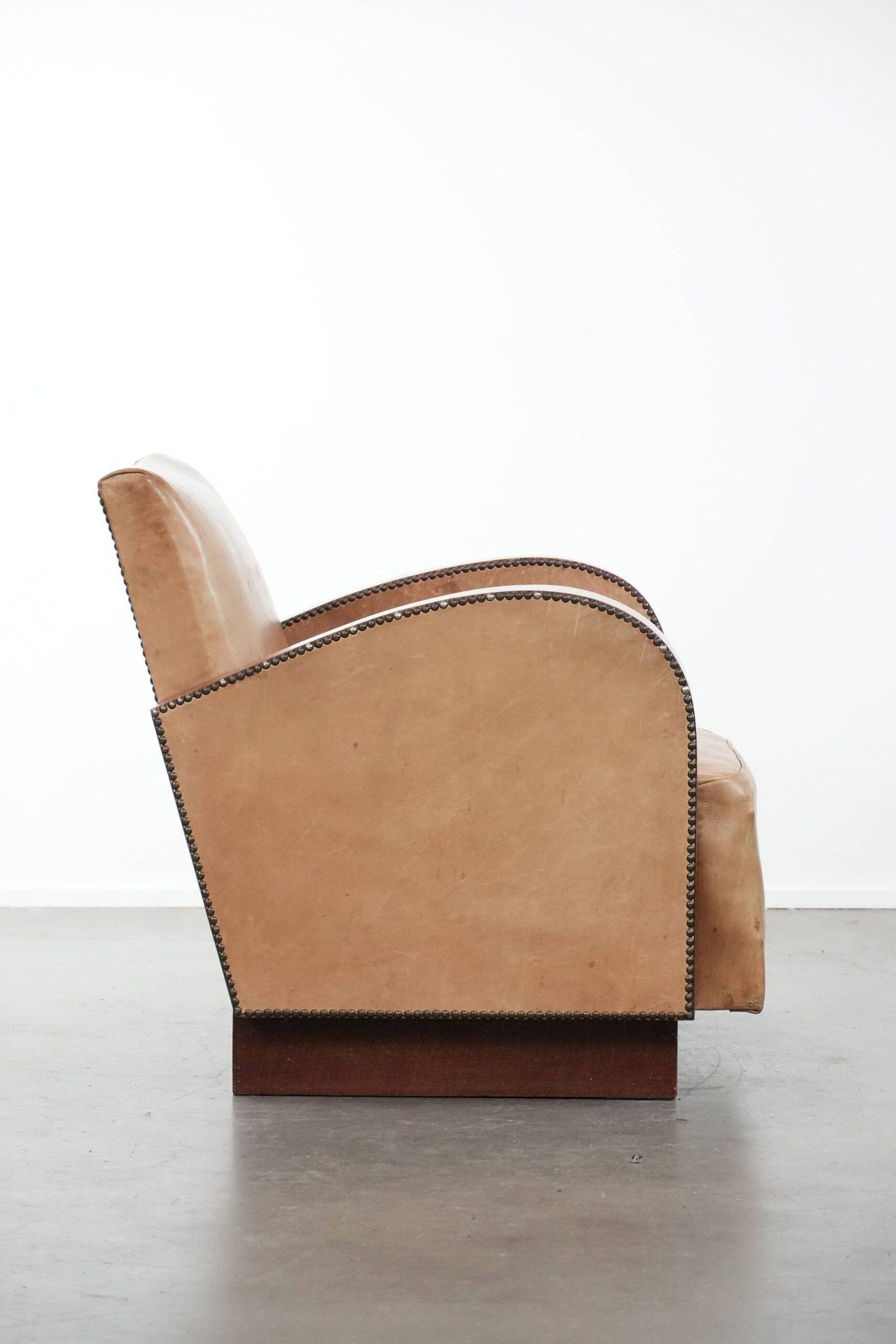 Art Deco design armchair in light cognac cowhide leather.