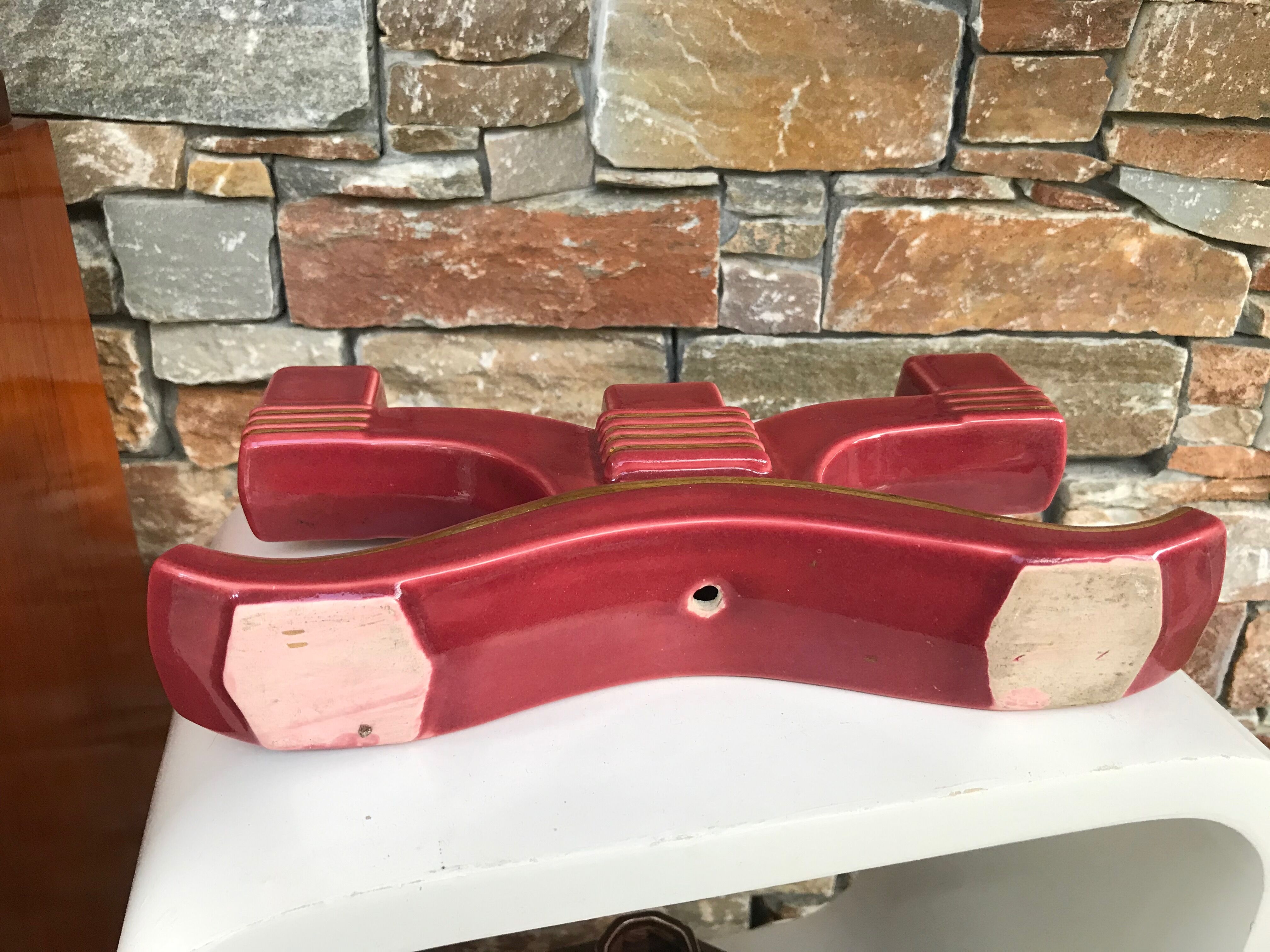 Former pair of burgundy ceramic candlesticks