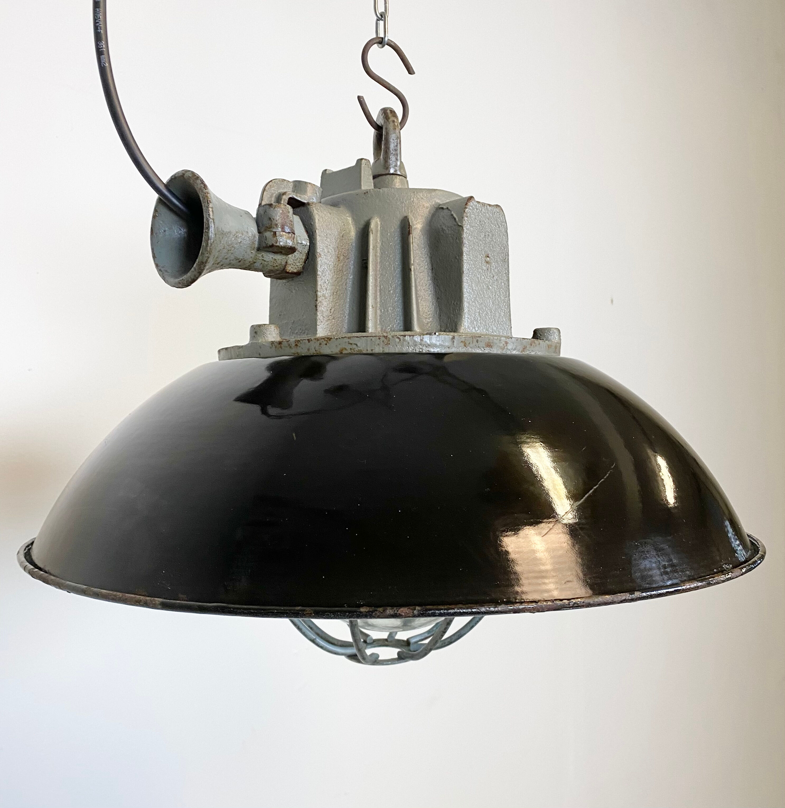 Black enamel and cast iron industrial cage pendant light , 1950s