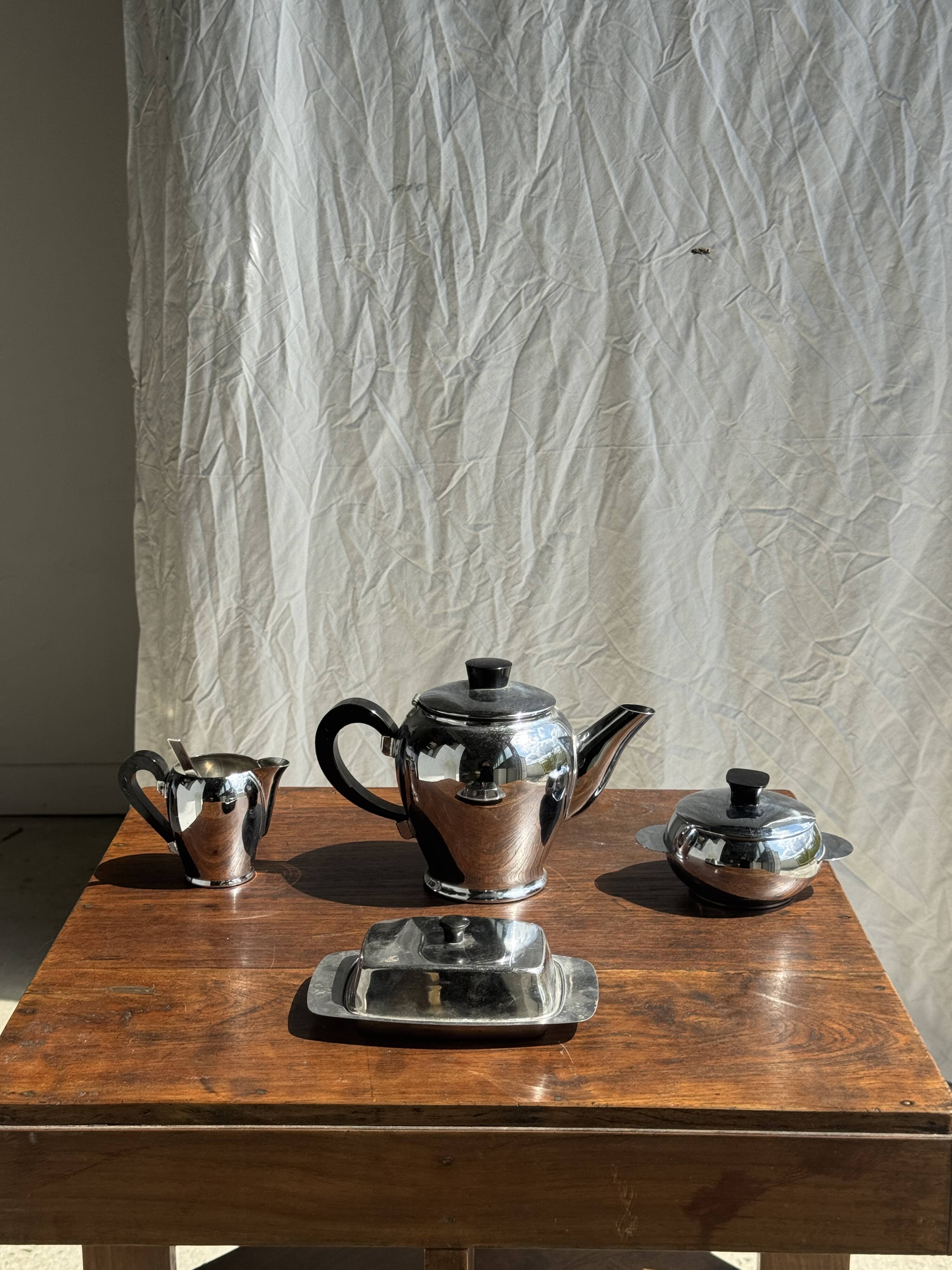 Tea set including teapot, milk jug, sugar bowl and butter dish