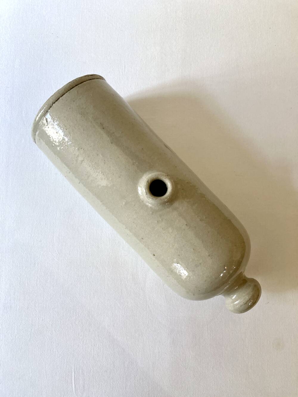 Old horizontal glazed stoneware hot water bottle, late 19th century.