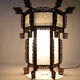 Asian wooden lantern carved with dragons and painted glass panels