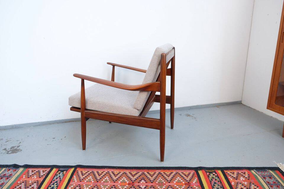 Vintage teak lounge chair, retro 1960s–70s style.