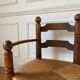 Straw and turned wood fireplace armchair in the style of Charles Dudouyt