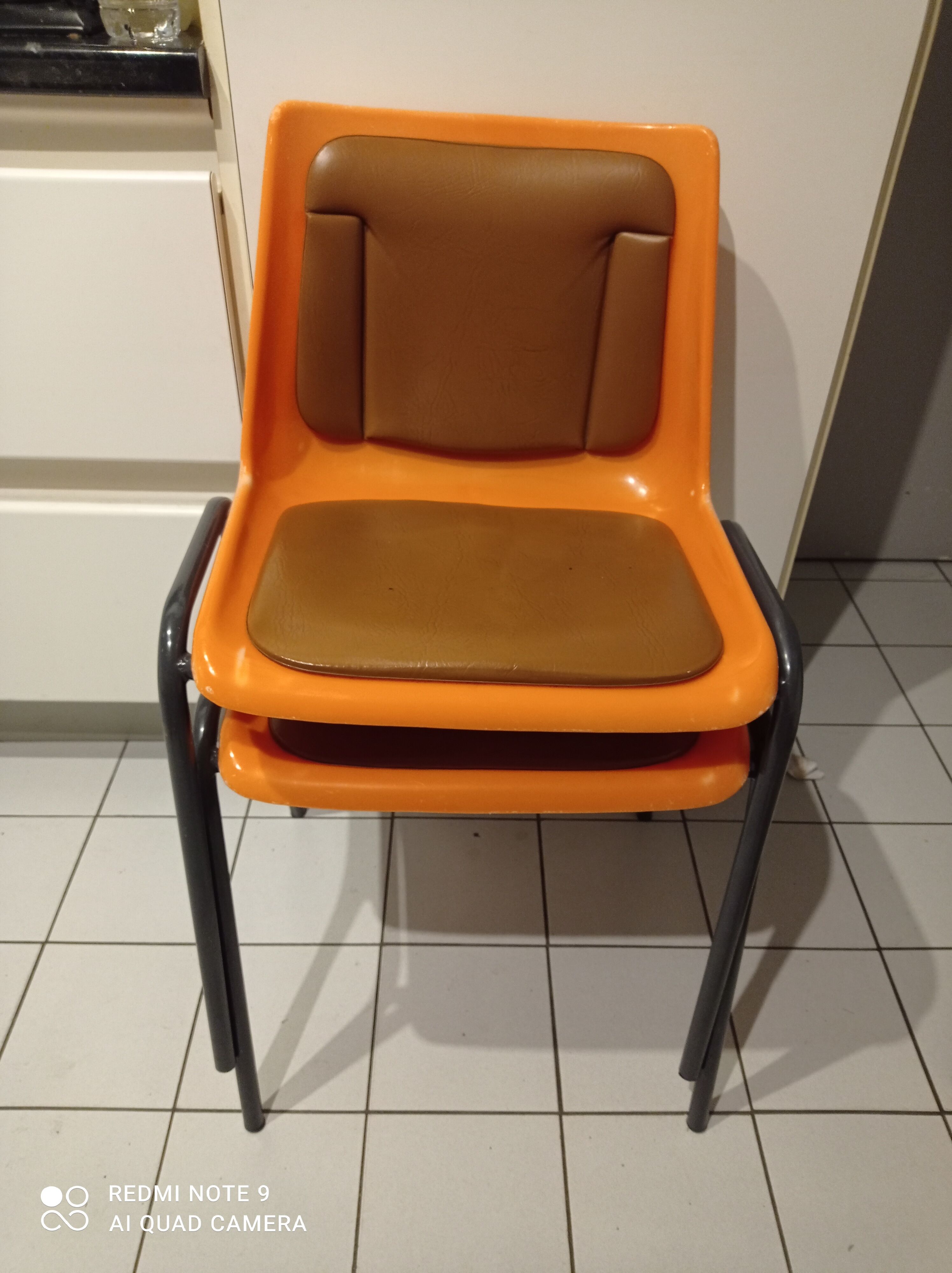 Chairs orange plastic shells seats and backrests imitation leather