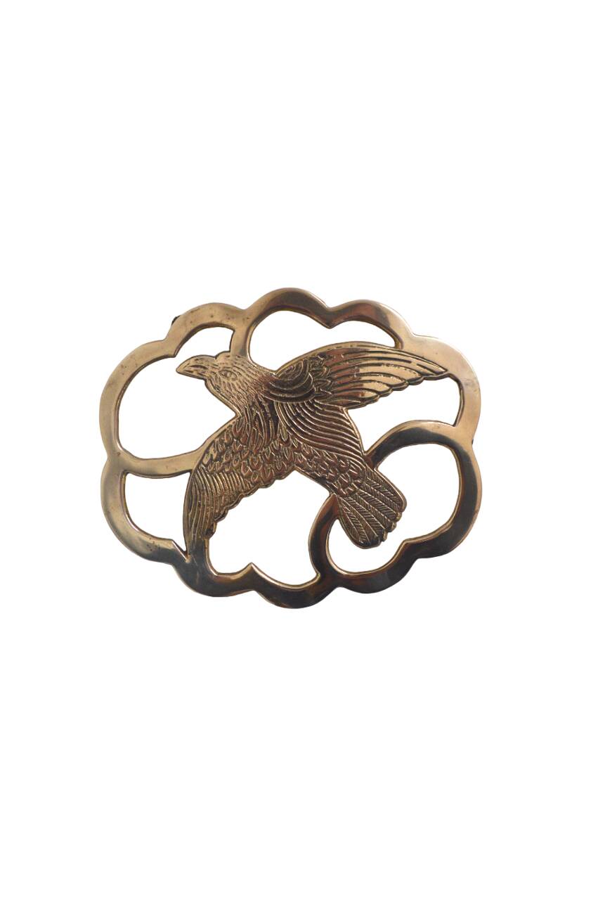 Brass bird trivet